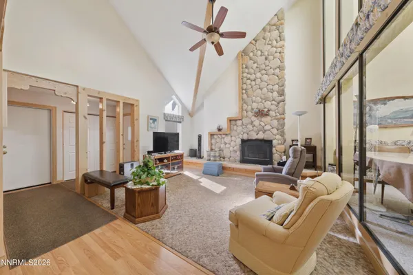 a living room with furniture a fireplace and a chandelier