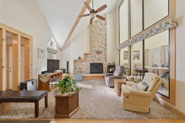 a living room with furniture a fireplace and a chandelier
