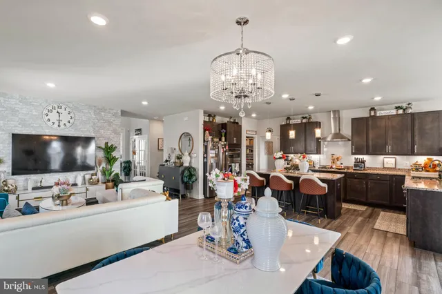 a kitchen with granite countertop stainless steel appliances a sink stove and cabinets