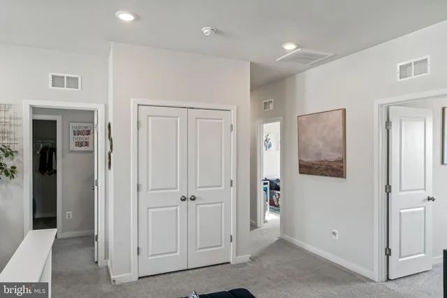 a living room with furniture a wooden floor and next to a window