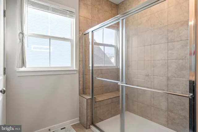 a white house that has a table and chairs in it