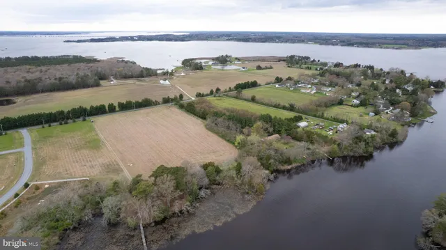 an aerial view of lake residential house with outdoor space and trees around