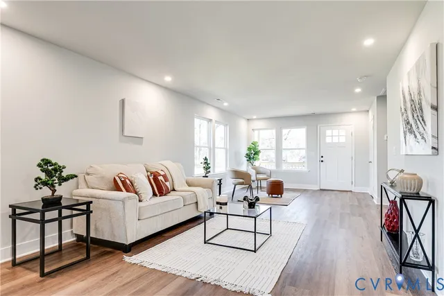a living room with furniture and wooden floor