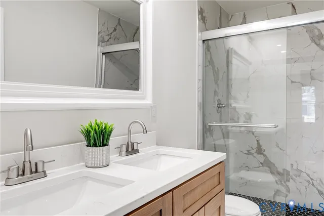 a bathroom with a sink a vanity and a shower