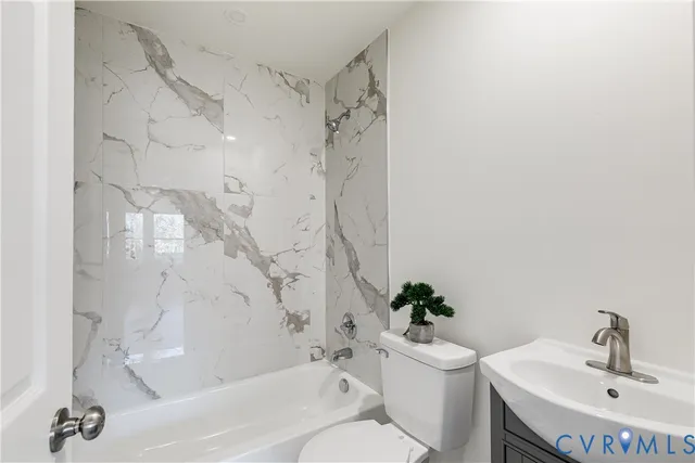 a bathroom with a sink a toilet and a bathtub