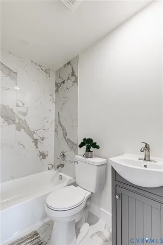 a bathroom with a sink a toilet and a bathtub