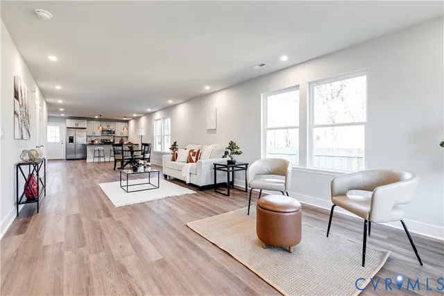 a living room with furniture a rug and a large window