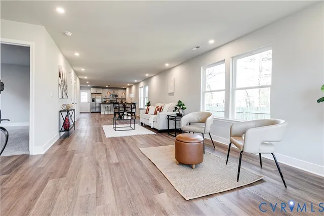 a living room with furniture a dining table and a potted plant
