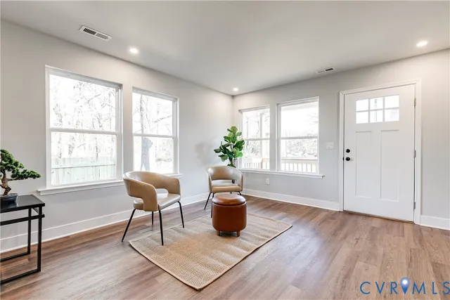a view of a livingroom with furniture and wooden floor