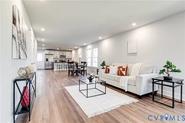 a living room with furniture and wooden floor
