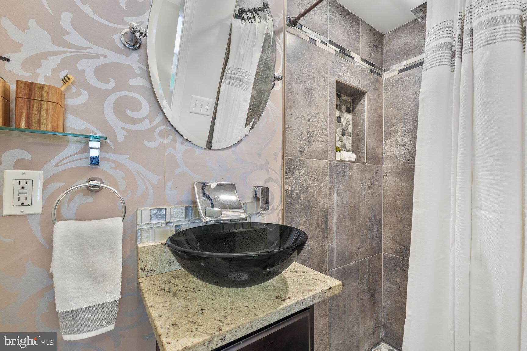 1268 16th Street Northeast Washington, DC 20002 - Photo 11 of 17 a bathroom with a sink a mirror and vanity
