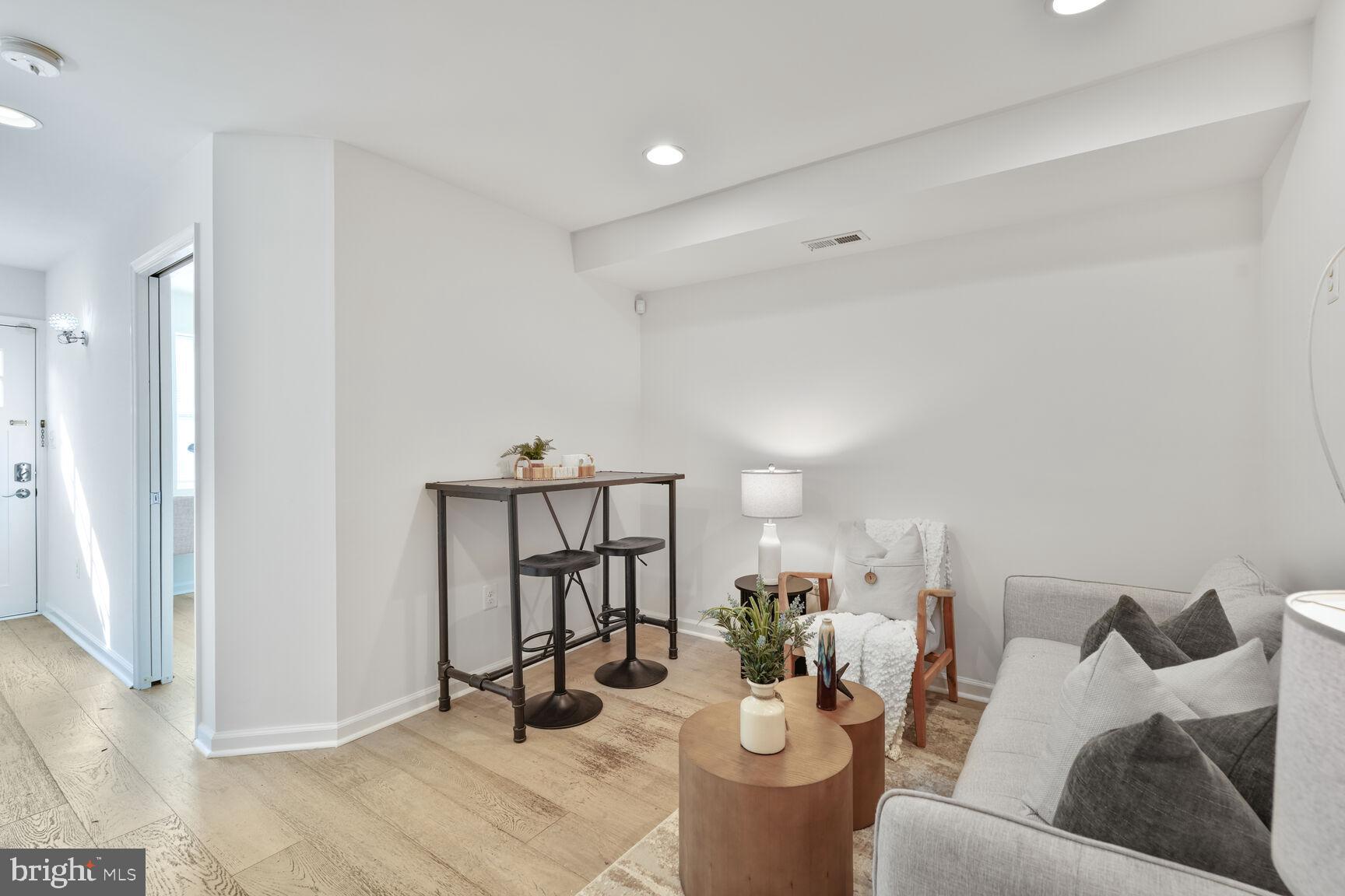 1268 16th Street Northeast Washington, DC 20002 - Photo 4 of 17 a living room with furniture a rug and white walls