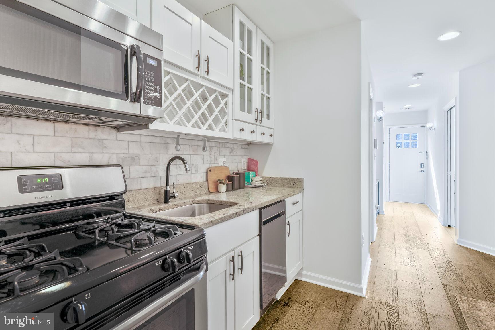 1268 16th Street Northeast Washington, DC 20002 - Photo 8 of 17 a kitchen with stainless steel appliances granite countertop a stove and a sink