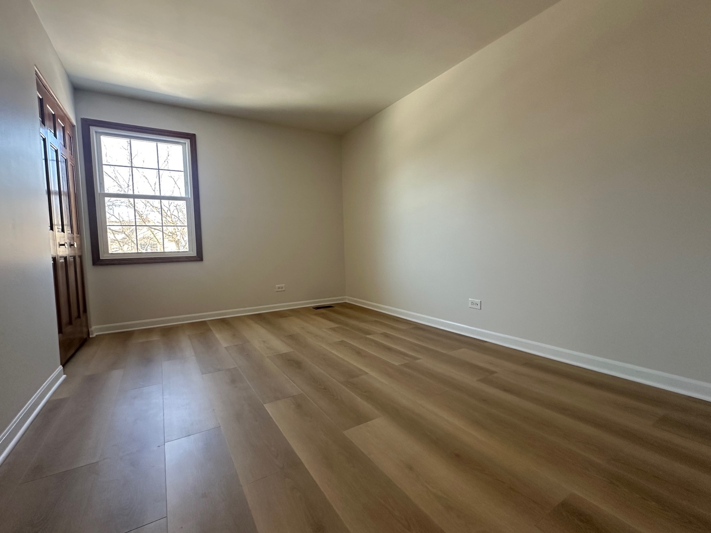 1712 Napoleon Drive Naperville, IL 60565 - Photo 18 of 19 an empty room with wooden floor and windows