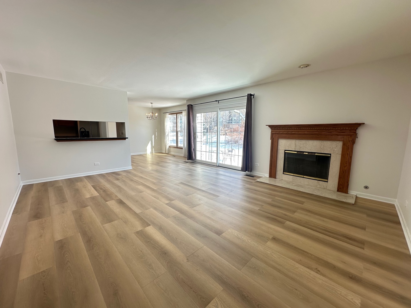1712 Napoleon Drive Naperville, IL 60565 - Photo 3 of 19 a view of an empty room with wooden floor and a window