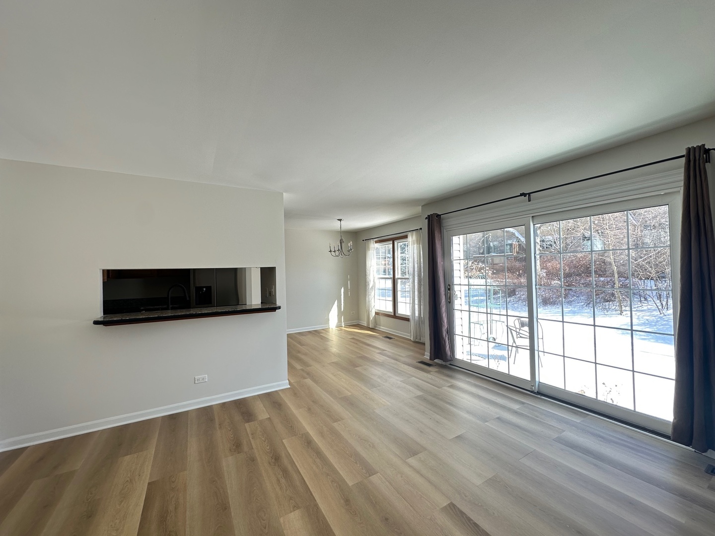 1712 Napoleon Drive Naperville, IL 60565 - Photo 4 of 19 a view of an empty room with wooden floor and a window