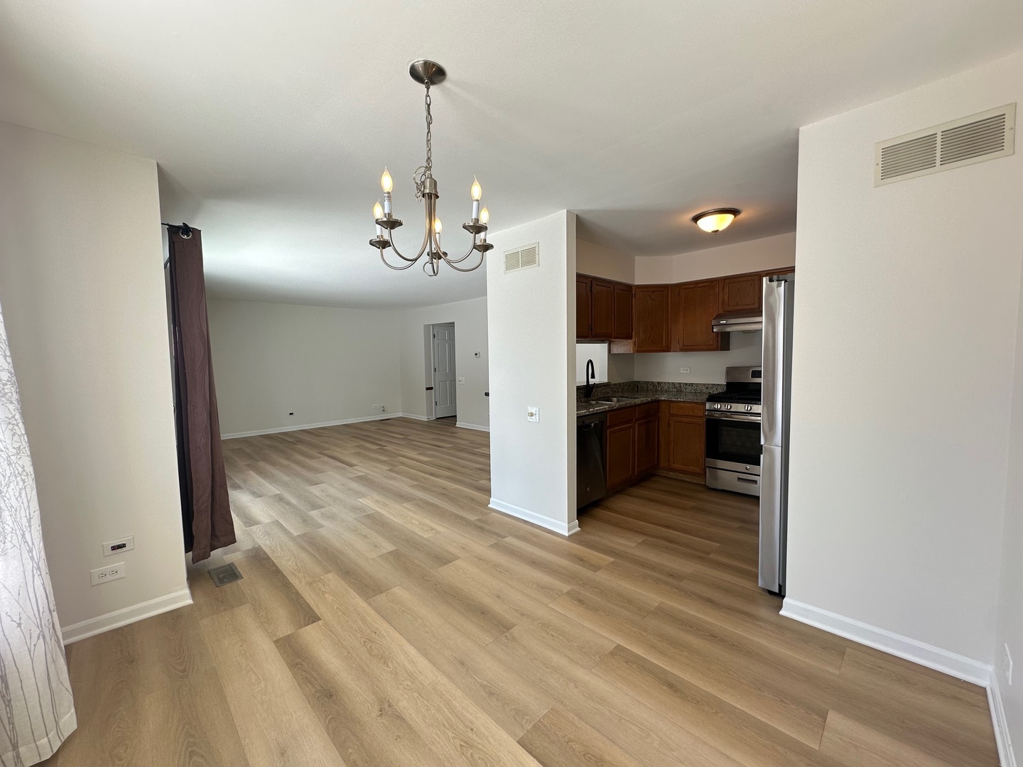1712 Napoleon Drive Naperville, IL 60565 - Photo 6 of 19 a view of a kitchen with a sink wooden cabinets and a floor to ceiling window