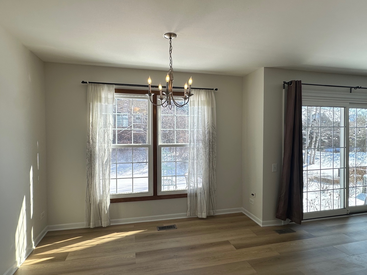 1712 Napoleon Drive Naperville, IL 60565 - Photo 9 of 19 a view of an empty room with wooden floor and a window