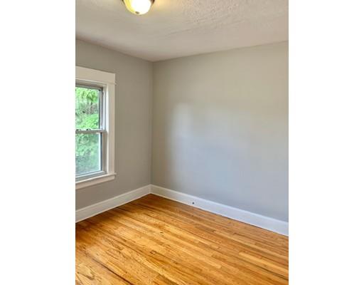 28 Griffin Street Springfield, MA 01104 - Photo 8 of 15 a view of an empty room with wooden floor and a window