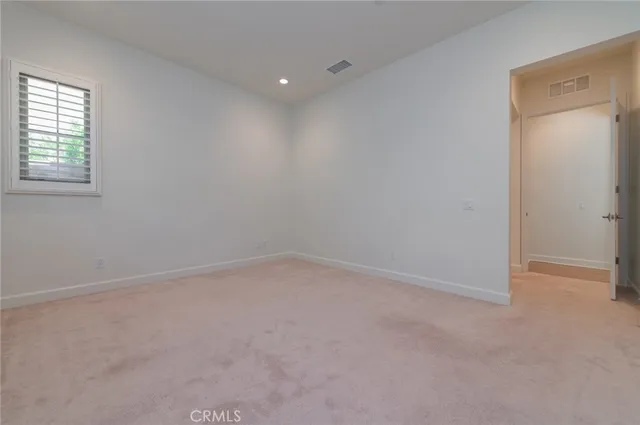 an empty room with a empty space and a window