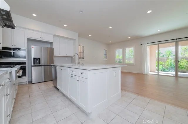 a kitchen with stainless steel appliances granite countertop a refrigerator sink and cabinets