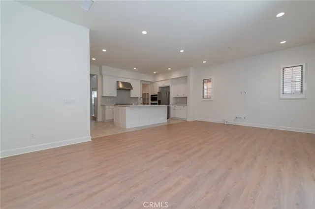 a view of a kitchen with a sink and a refrigerator