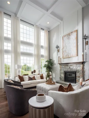 a living room with fireplace furniture and a large window