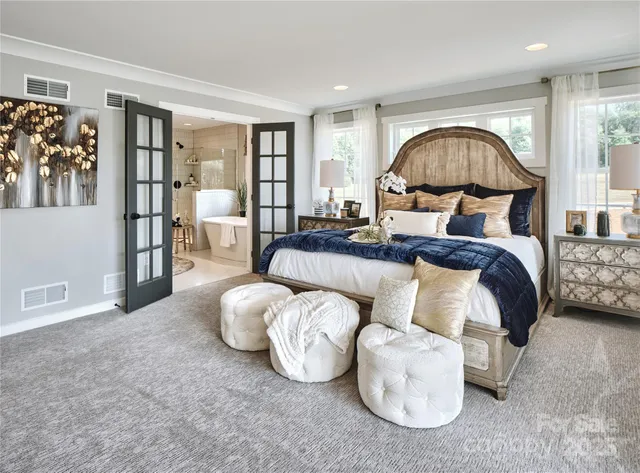 a bedroom with bed and a large window