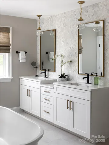 a bathroom with a double vanity sink mirror and