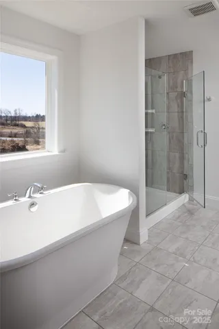 a bathroom with a bathtub and shower