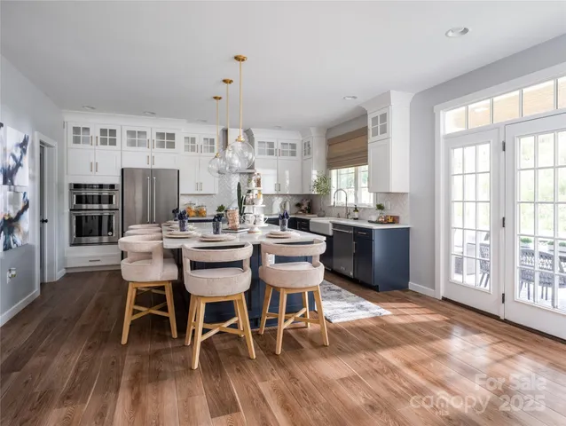 a dining room with furniture window and wooden floor
