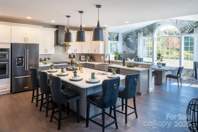 a large kitchen with a table and chairs