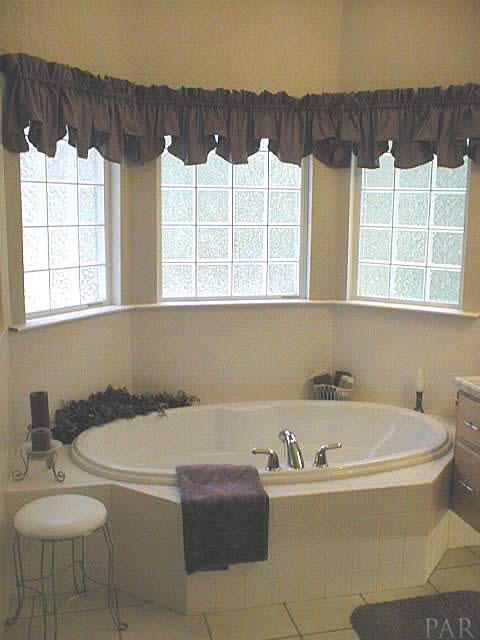 5965 Clark Road Milton, FL 32570 - Photo 11 of 16 a bathroom with a bathtub and a sink