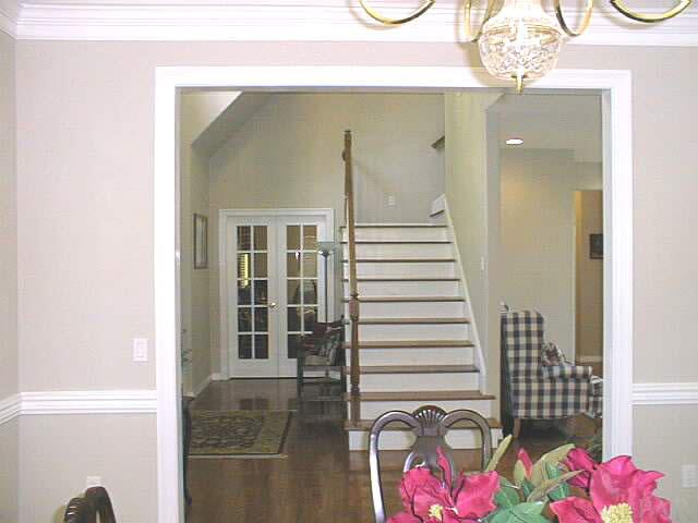 5965 Clark Road Milton, FL 32570 - Photo 3 of 16 a view of hallway with stairs and chandelier