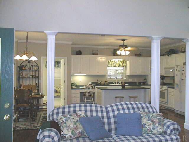 5965 Clark Road Milton, FL 32570 - Photo 7 of 16 a kitchen with stainless steel appliances kitchen island granite countertop a refrigerator and stove