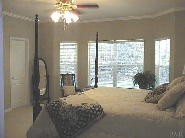 5965 Clark Road Milton, FL 32570 - Photo 10 of 16 a bedroom with a large bed and a window