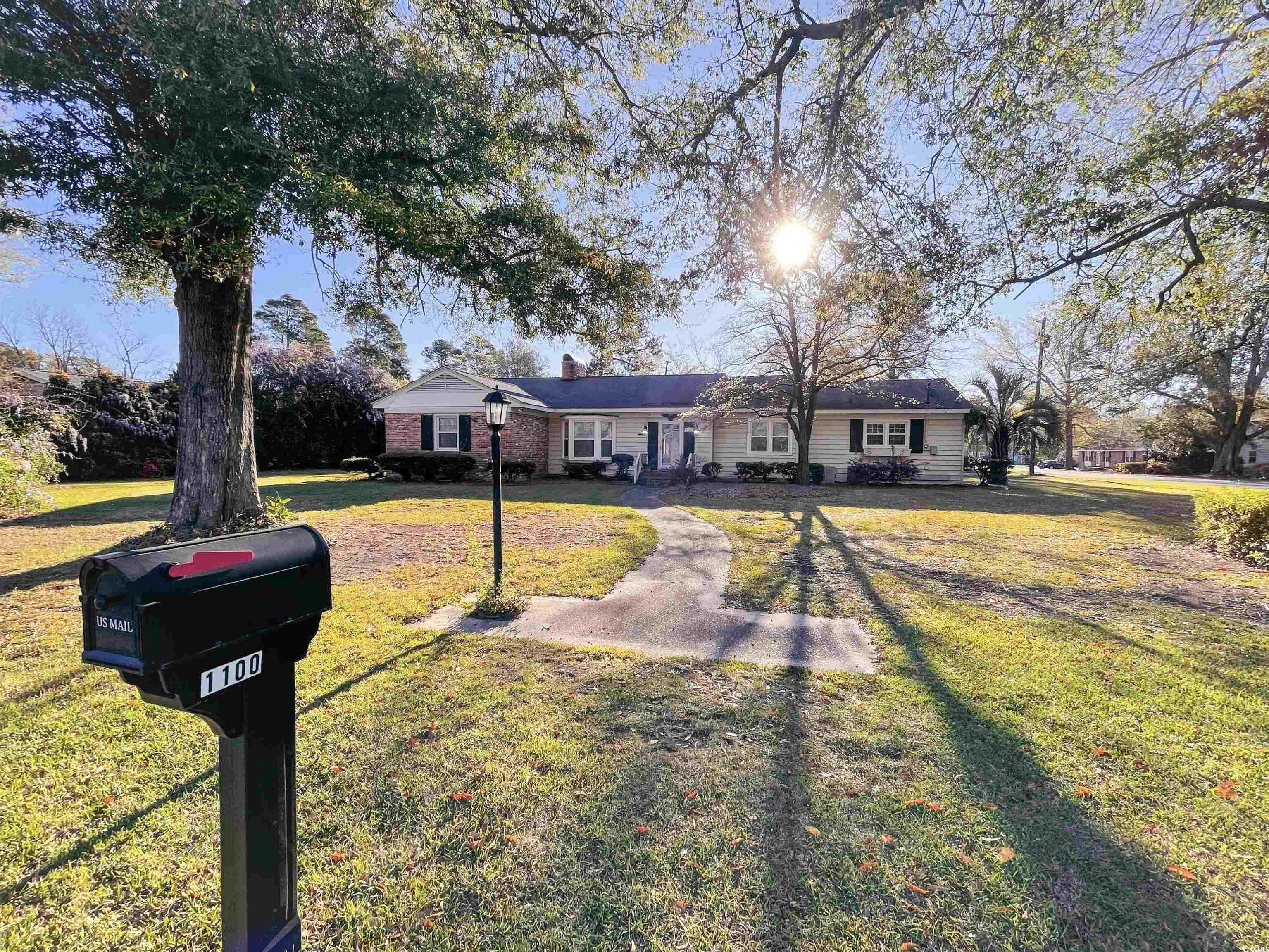 Ranch-style house with a front lawn and a chimney