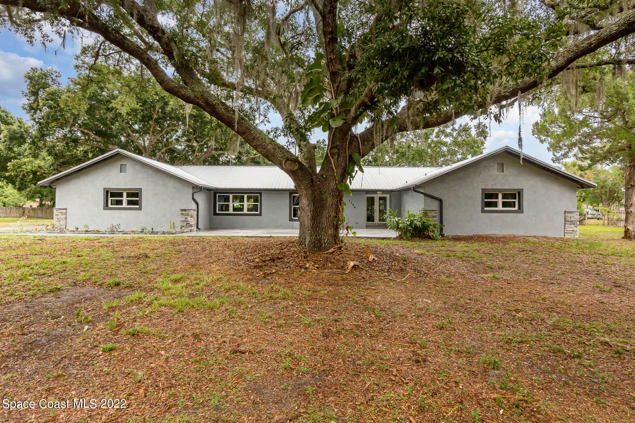 2380 Friday Road Cocoa, FL 32926 - Photo 1 of 30 a house with trees in the background