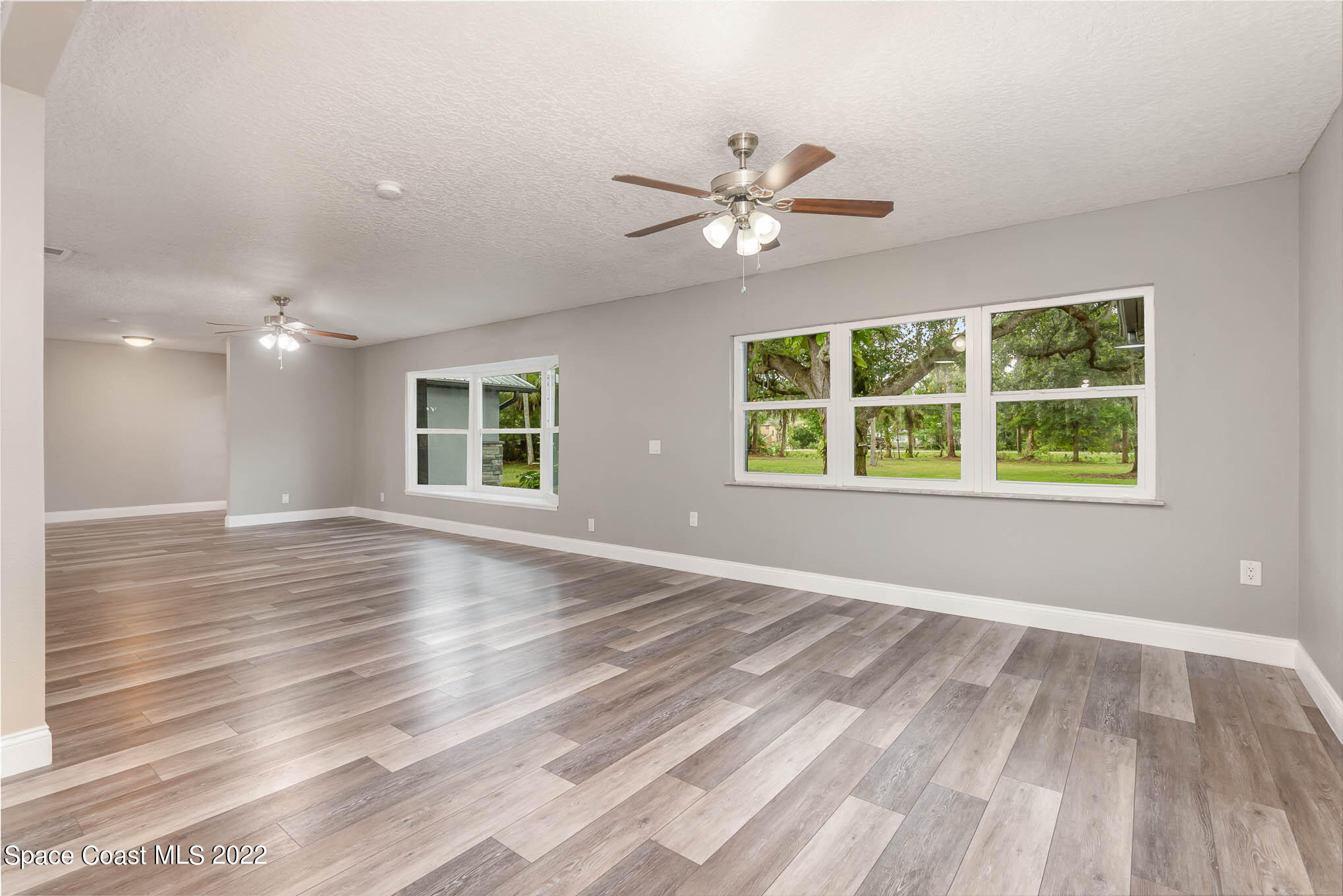 2380 Friday Road Cocoa, FL 32926 - Photo 13 of 30 a view of an empty room with a window and wooden floor