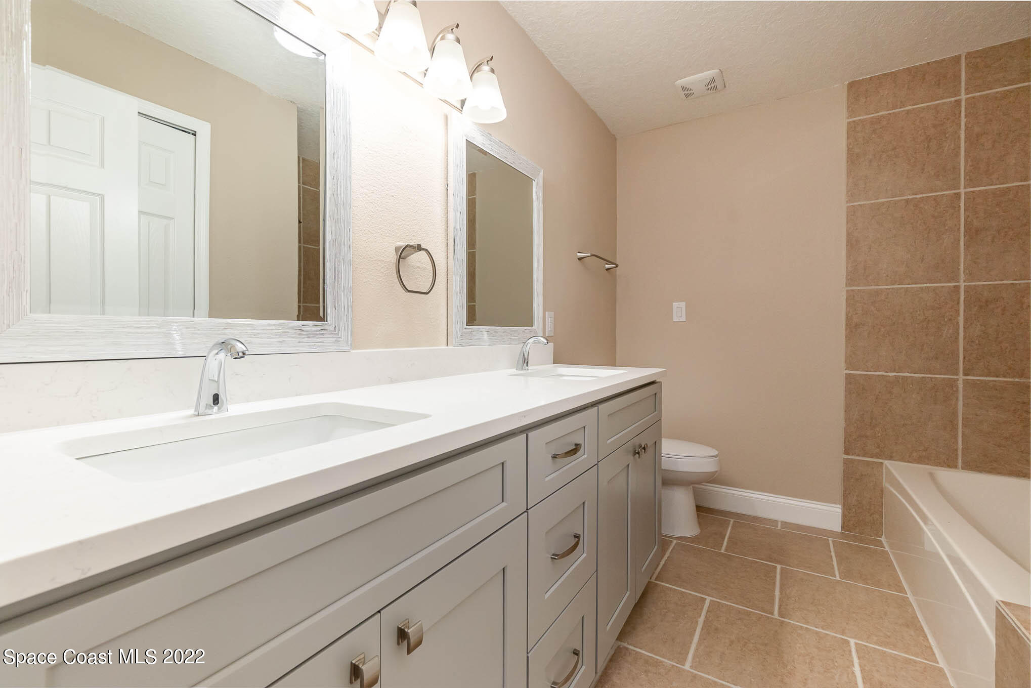 2380 Friday Road Cocoa, FL 32926 - Photo 14 of 30 a bathroom with a sink a toilet and a mirror
