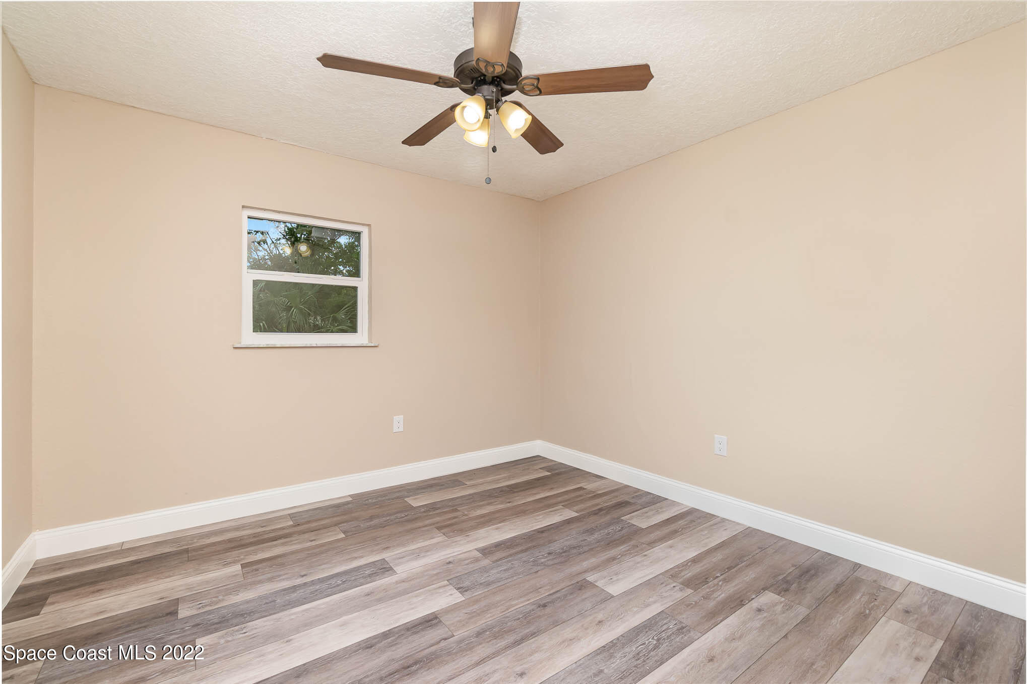2380 Friday Road Cocoa, FL 32926 - Photo 19 of 30 an empty room with a window and a ceiling fan