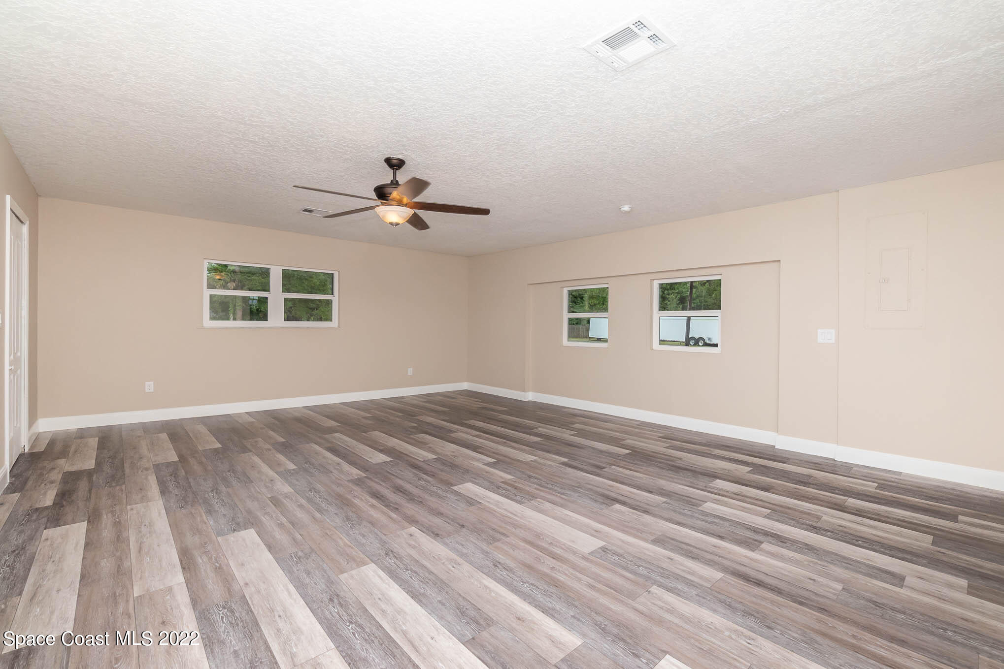 2380 Friday Road Cocoa, FL 32926 - Photo 21 of 30 a view of an empty room with a window and wooden floor
