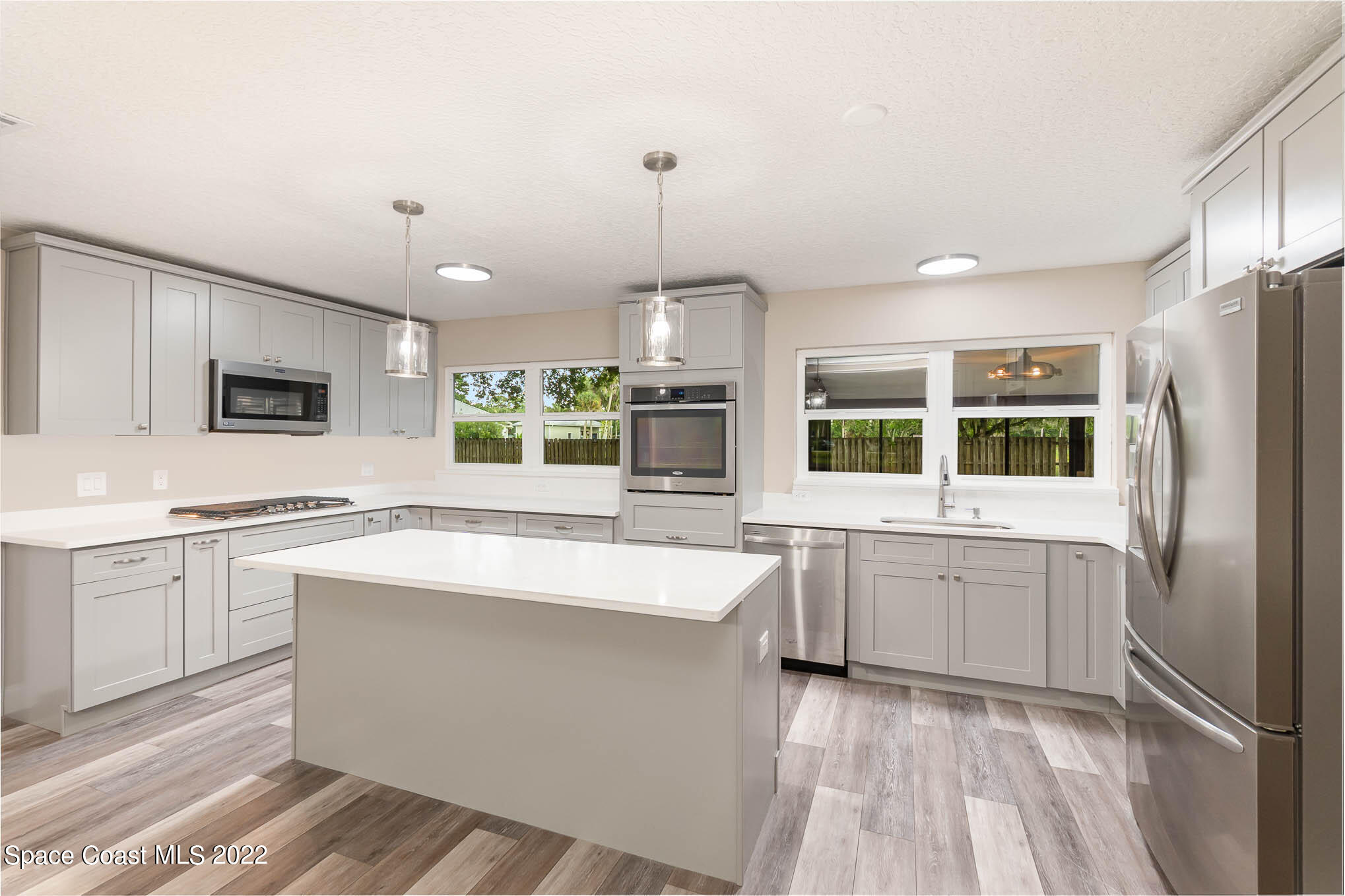 2380 Friday Road Cocoa, FL 32926 - Photo 7 of 30 a large kitchen with kitchen island a sink stainless steel appliances and cabinets