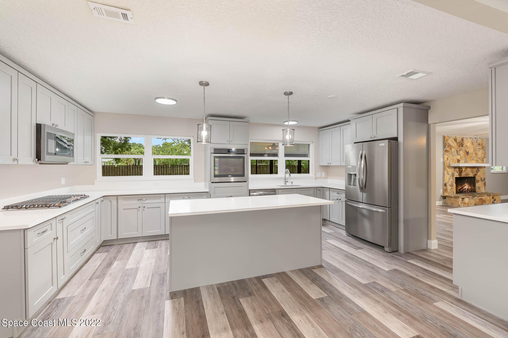 2380 Friday Road Cocoa, FL 32926 - Photo 8 of 30 a large kitchen with kitchen island a sink stainless steel appliances and cabinets