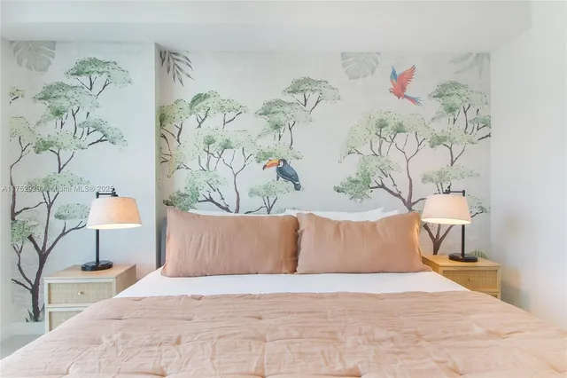 a bedroom with a bed and a painting on the wall