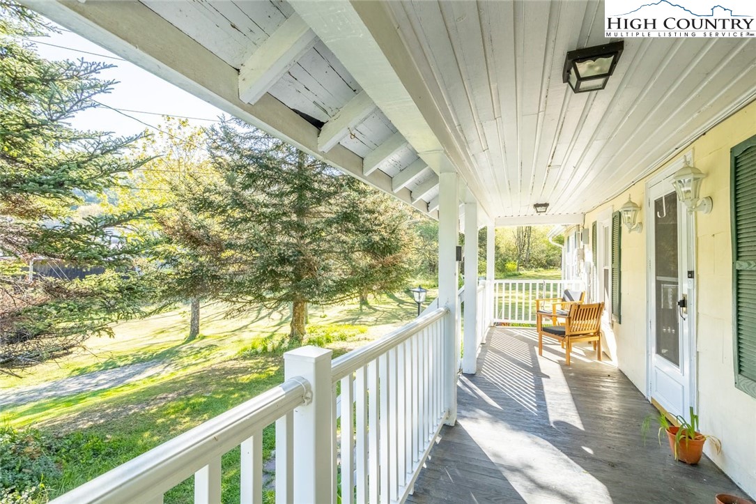 165 V L Moretz Road Deep Gap, NC 28618 - Photo 3 of 38 a view of porch with wooden floor and furniture