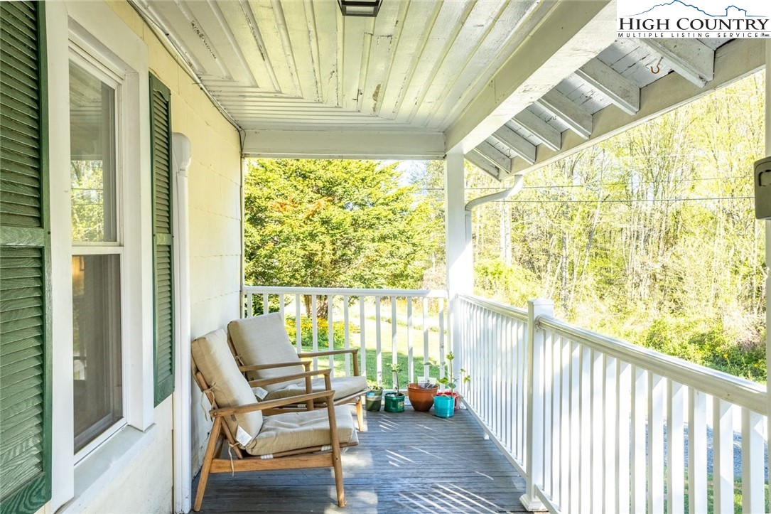 165 V L Moretz Road Deep Gap, NC 28618 - Photo 4 of 38 a view of a porch with chairs and furniture
