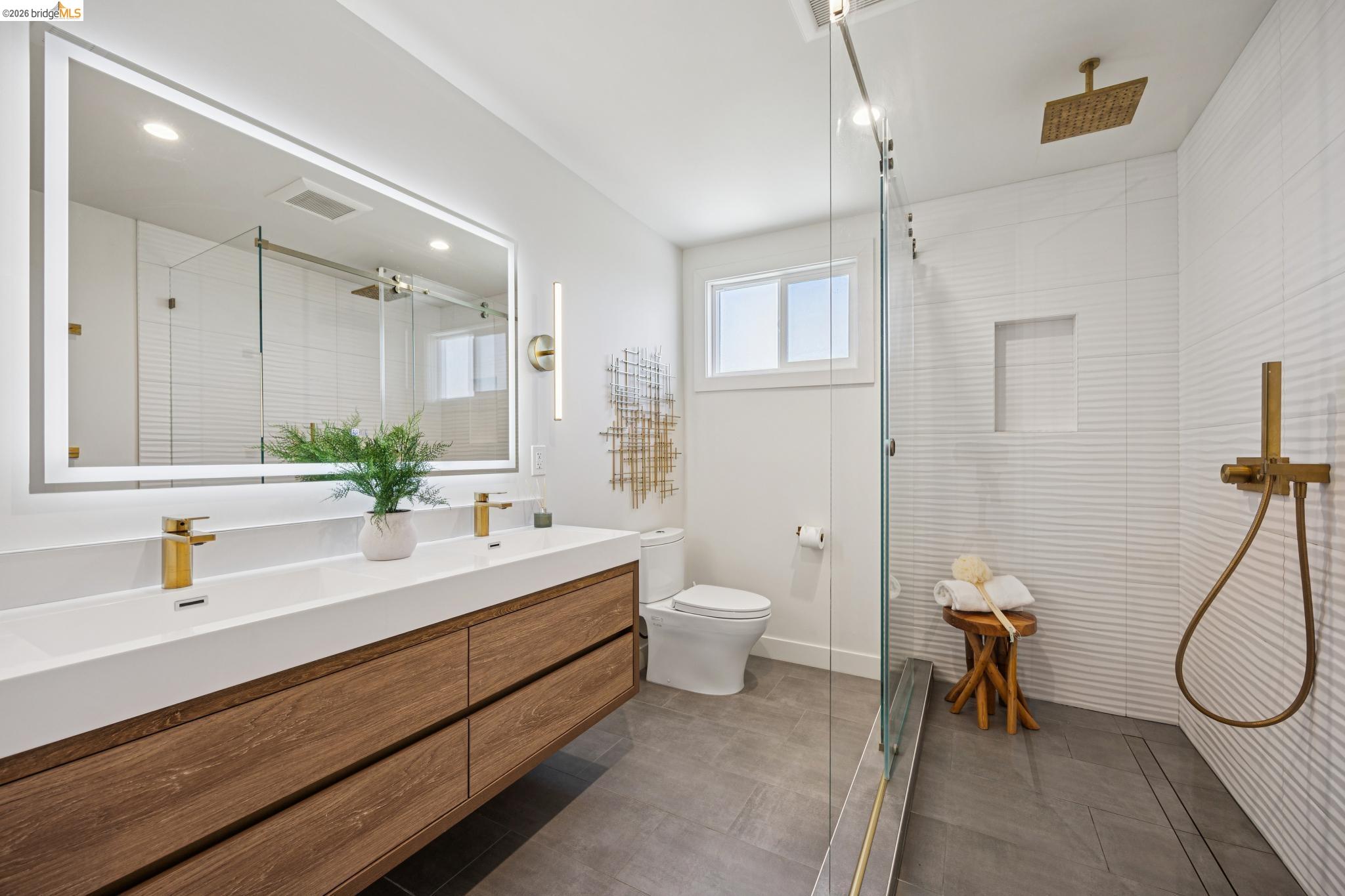 11 Belinda Court San Ramon, CA 94583 - Photo 24 of 33 Bathroom featuring a floating wood-finish double vanity with integrated rectangular sinks and gold-tone fixtures