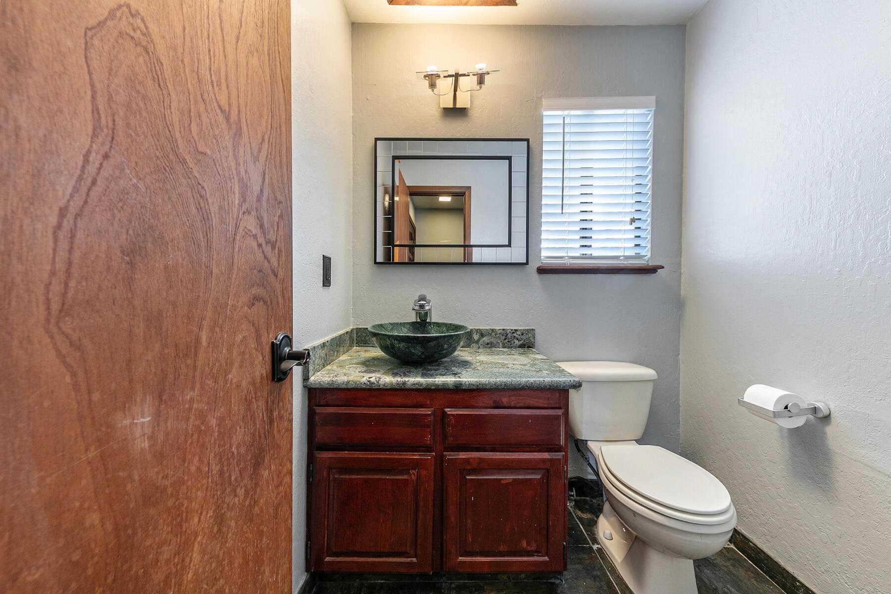 10806 Manchester Drive Truckee, CA 96161 - Photo 13 of 28 a bathroom with a granite countertop toilet and a sink