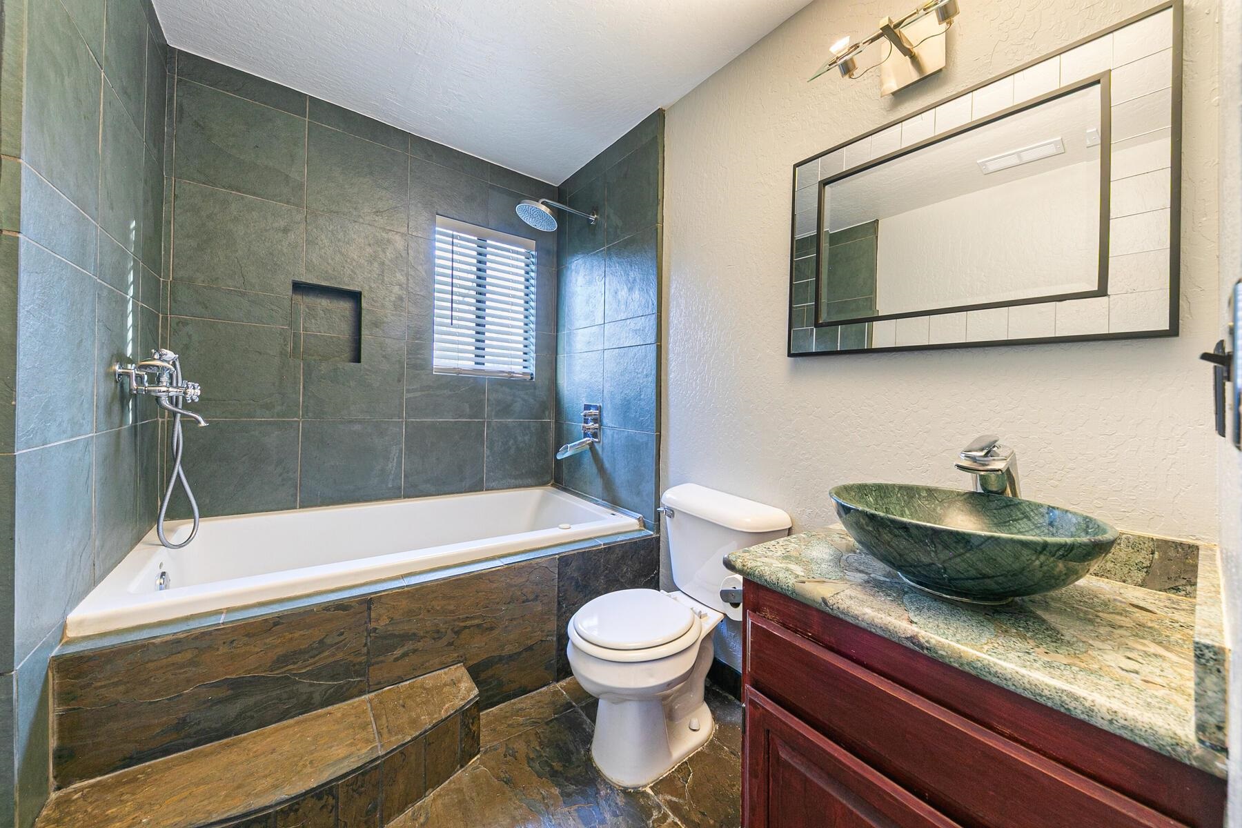 10806 Manchester Drive Truckee, CA 96161 - Photo 22 of 28 a bathroom with a granite countertop sink a toilet and bathtub